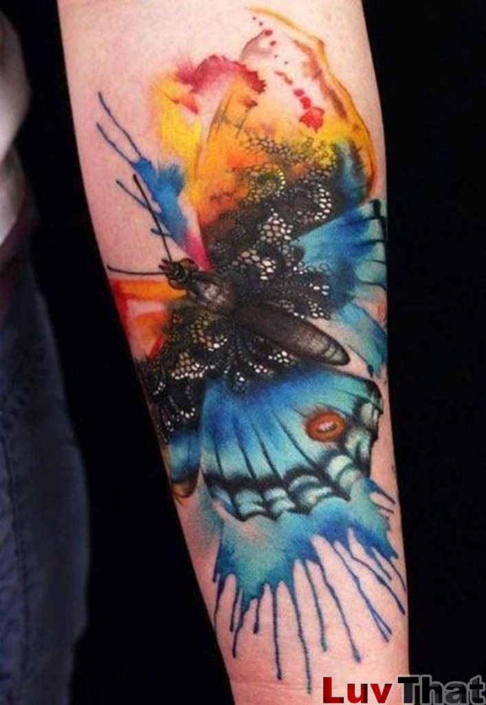 watercolor style huge butterfly tattoo on forearm
