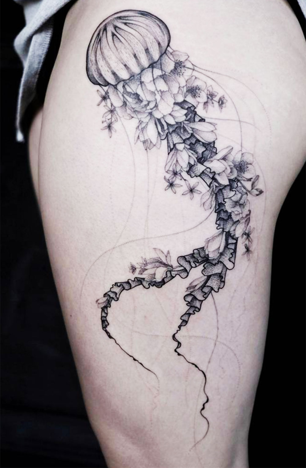long flowing black ink jellyfish tattoo with flowers